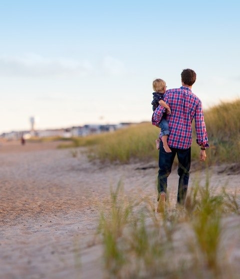 Man and child on beach